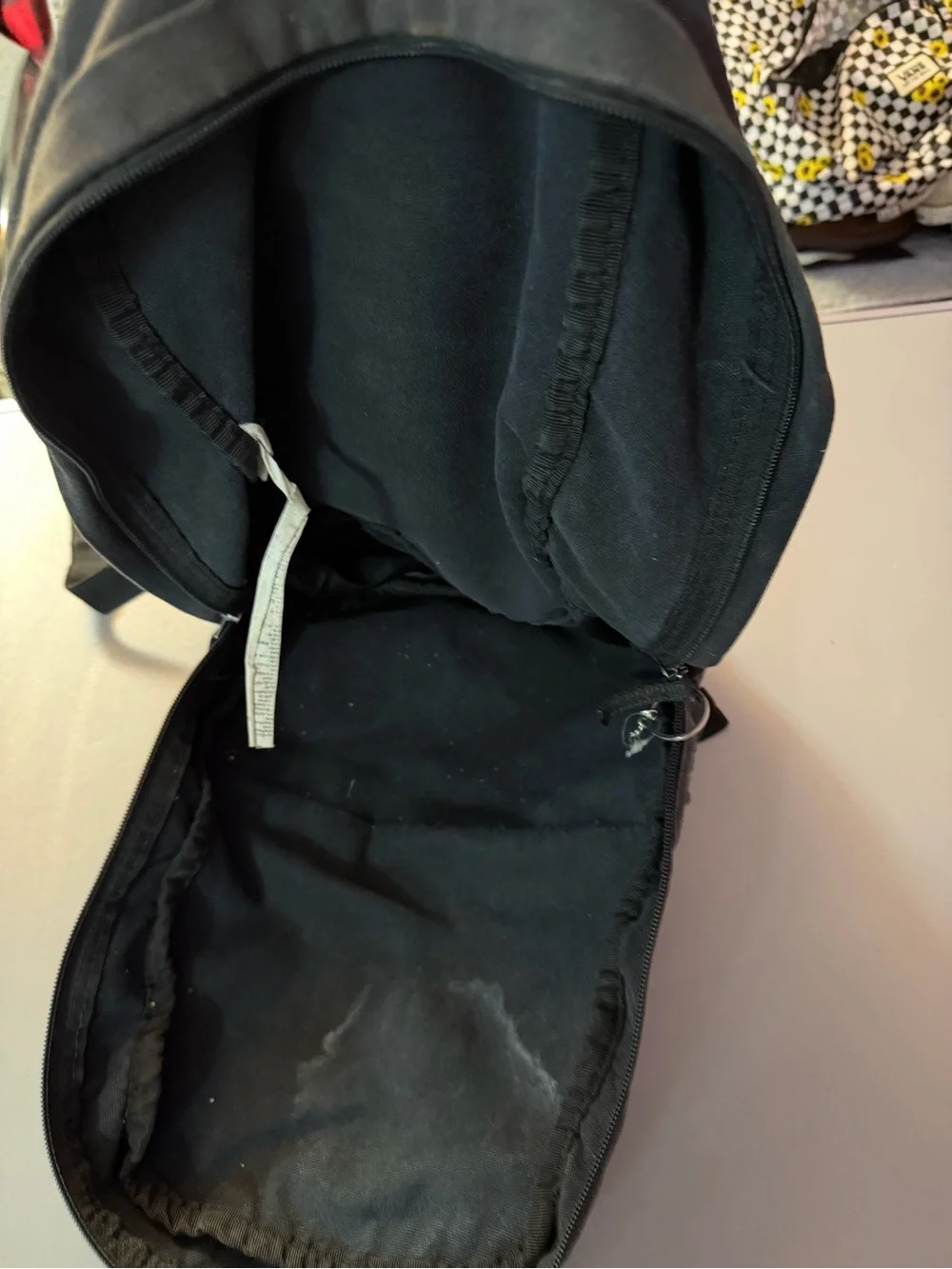 Vans Black Canvas Backpack with Red Lettering and Patch Accents